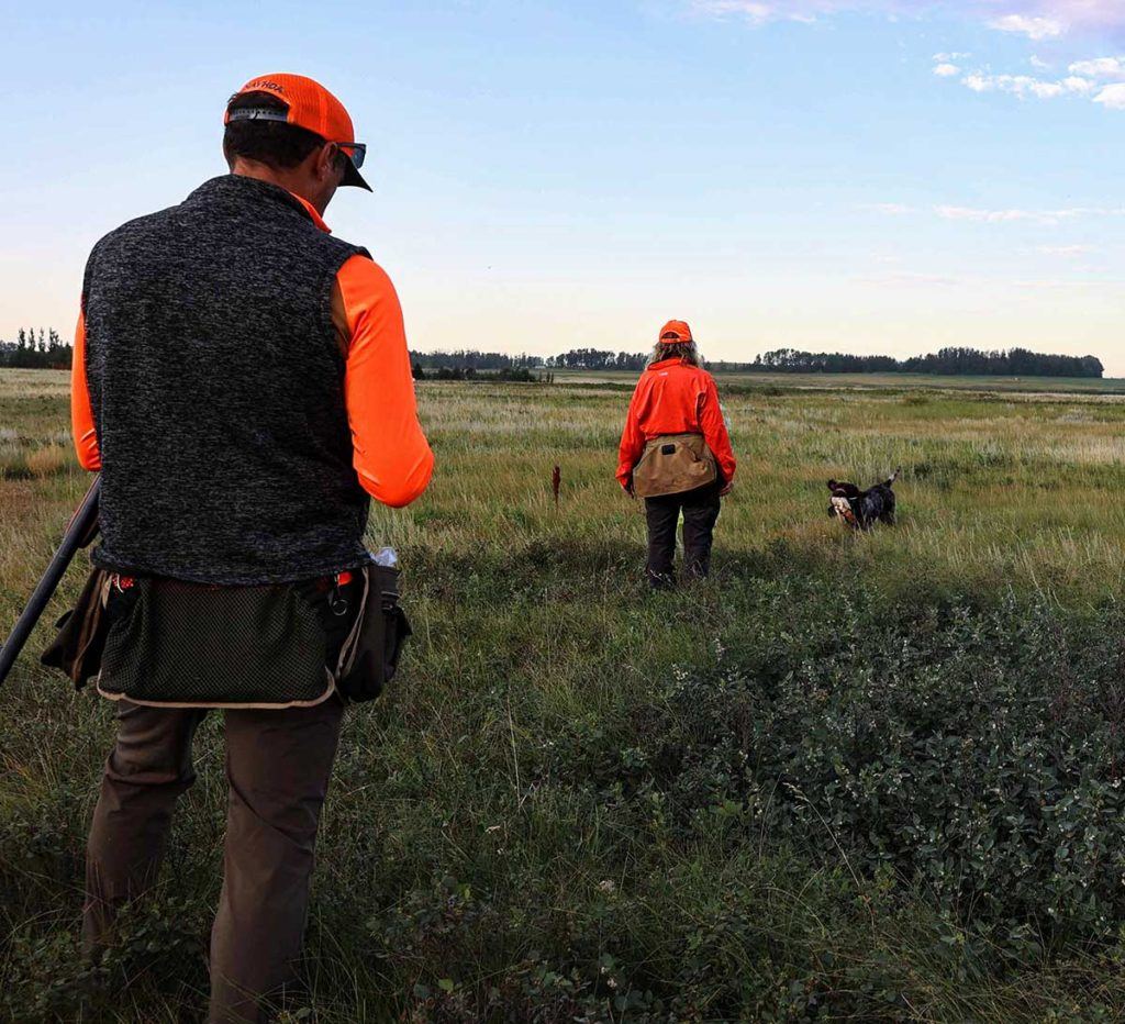 a group of people in a field with a dog