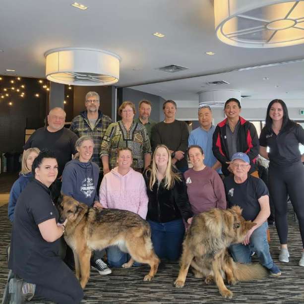 a group of people posing for a picture with a dog