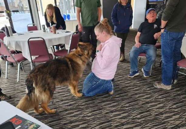 a group of people and a dog in a room