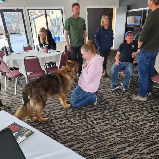 a group of people and a dog in a room